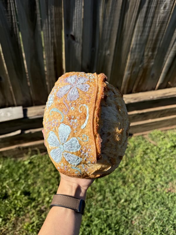 Sourdough loaf decorated with hand-painted pastel flowers